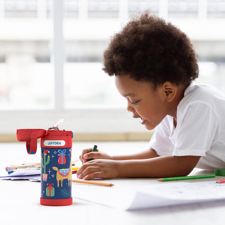 Young boy coloring with 12 ounce FUNtainer bottle next to him, animal prints pattern.