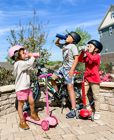 Kids outside, drinking from their Thermos Funtainer water bottles.