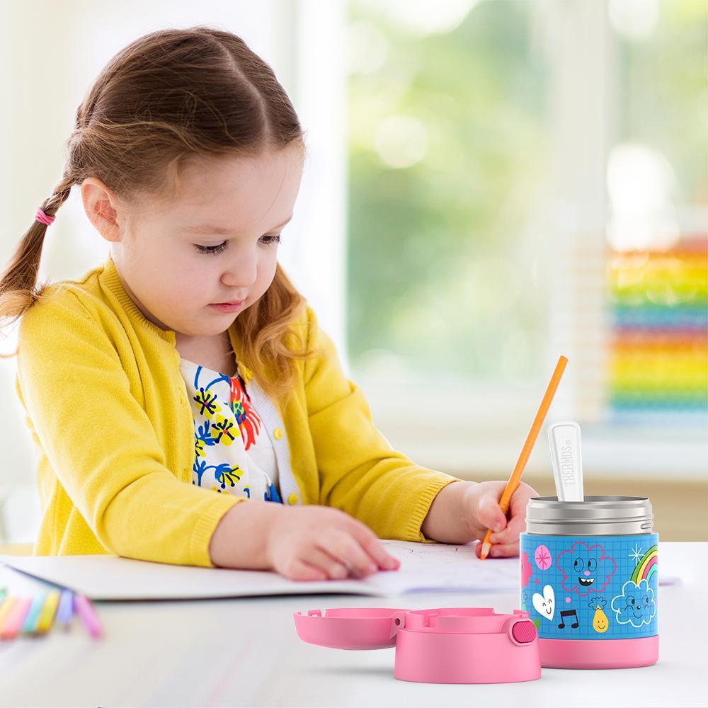 Girl sitting at table coloring with an open 10 ounce Funtainer food jar open in front of her. 