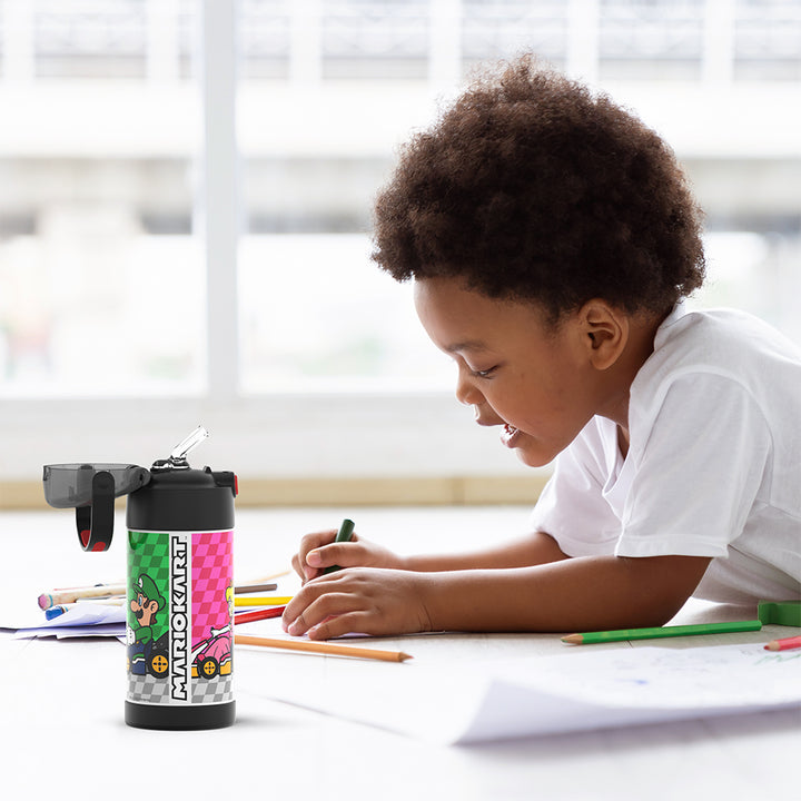 Boy sitting at a table coloring, with the 12 ounce Funtainer Mario Kart water bottle opened next to him.