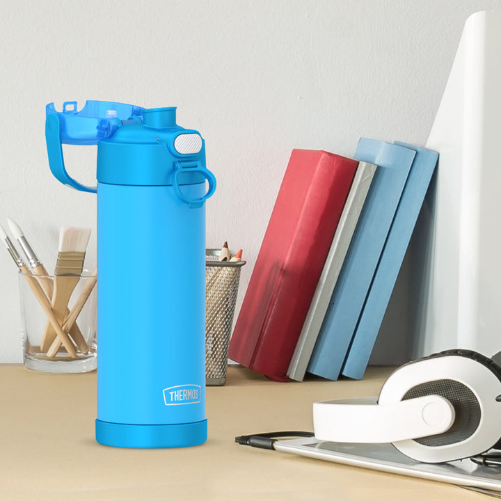 16-ounce Kids Stainless Steel Water Bottle with Spout and locking lid, Electric Blue, side view, lid open, sitting on a table.