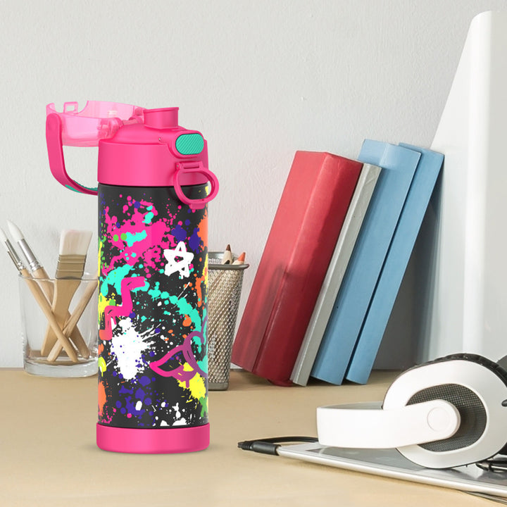 16-ounce Funtainer Stainless Steel Water Bottle with Spout and locking lid, Pink Graffiti, side view, lid open, sitting on a table.