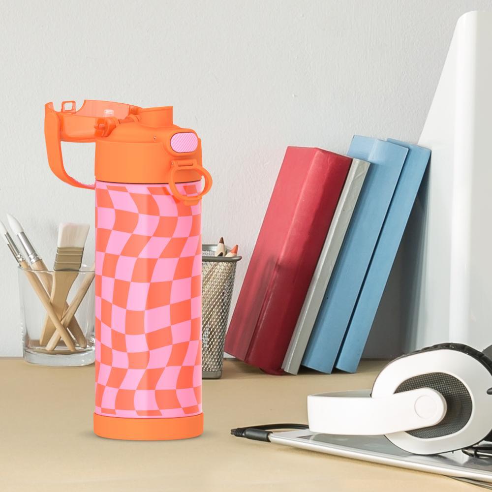 16-ounce Funtainer Stainless Steel Water Bottle with Spout and locking lid, Orange and Pink Wavy Checkers, side view, lid open, sitting on a table.